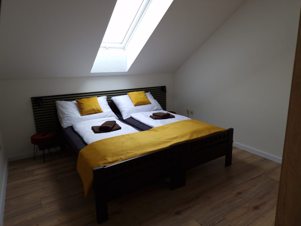 Standard room interior with double bed and roof window
