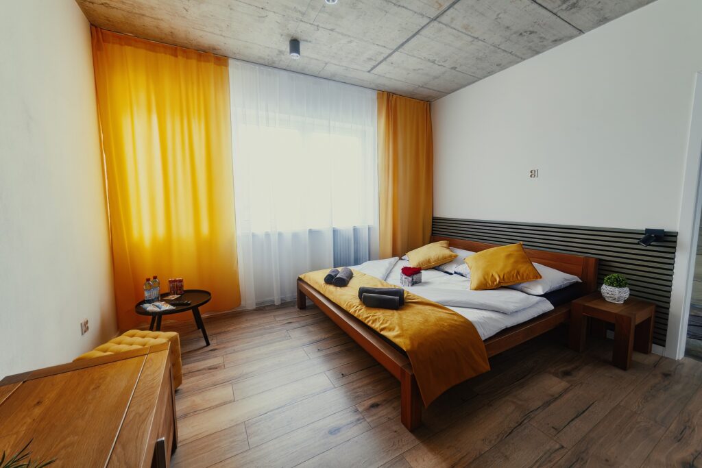 Interior of apartment with double bed and big window