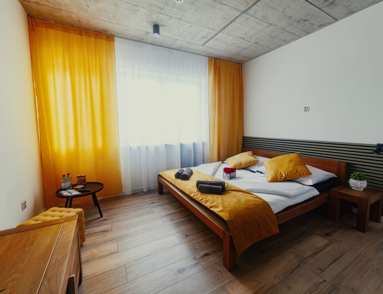 Interior of apartment with double bed and big window